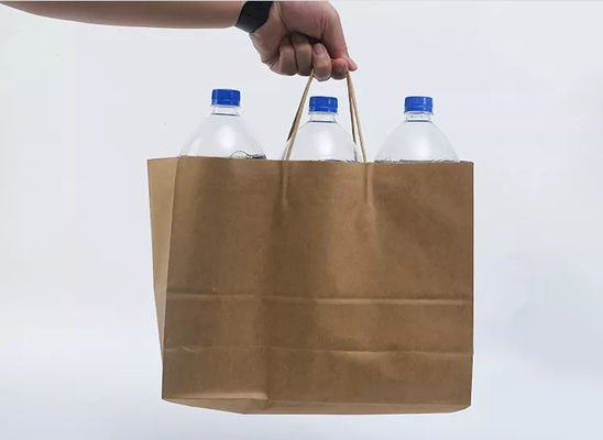 クラフトのテイクアウェイを印刷するロゴは生物分解性買物をするギフト包装袋を袋に入れる